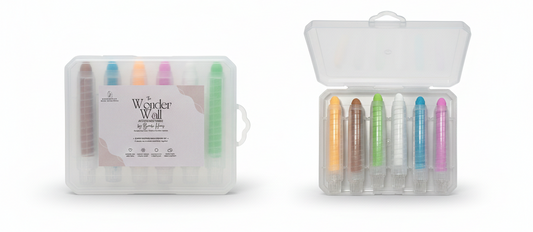 Set of colorful markers in a clear plastic case on a white background