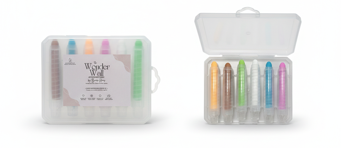 Set of colorful markers in a clear plastic case on a white background